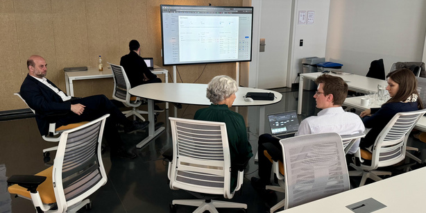 Project partner sitting together and discussing 