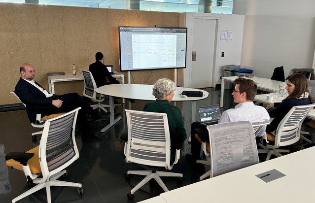 Project partner sitting together and discussing 